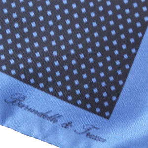 Dettaglio fantasia geometrica a quadri su pochette da taschino in seta blu e carta da zucchero