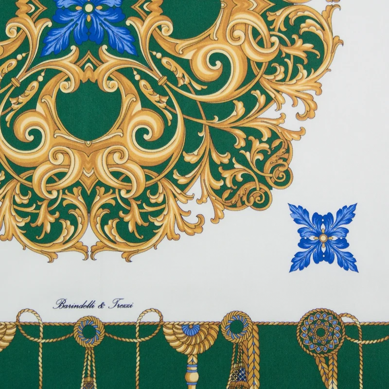 dettaglio del foulard in seta verde smeraldo con corde decorative e motivi ornamentali