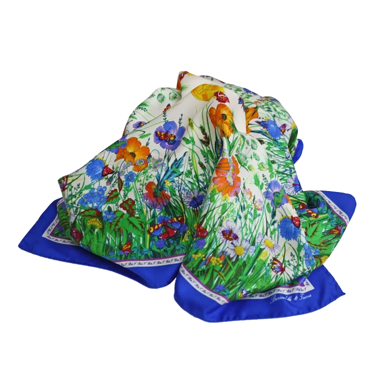 foulard in seta drappeggiato con fiori arancioni, margherite, farfalle e bordo blu elettrico
